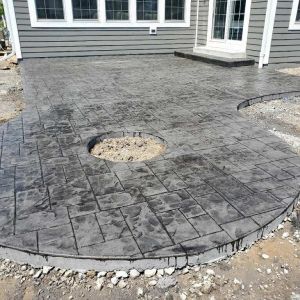 Ashler slate concrete stamp patio and fire pit by Nuno & Jorge
