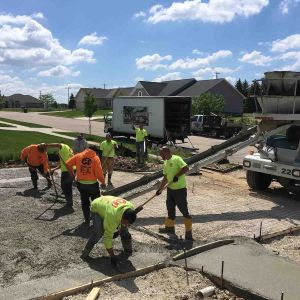 Nuno Jorge working crew on new concrete driveway